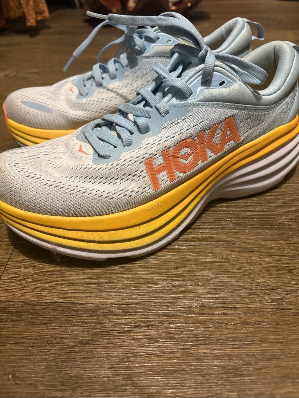 Hoka Women's Light Blue Running Shoes with Yellow Midsole and Orange Logo